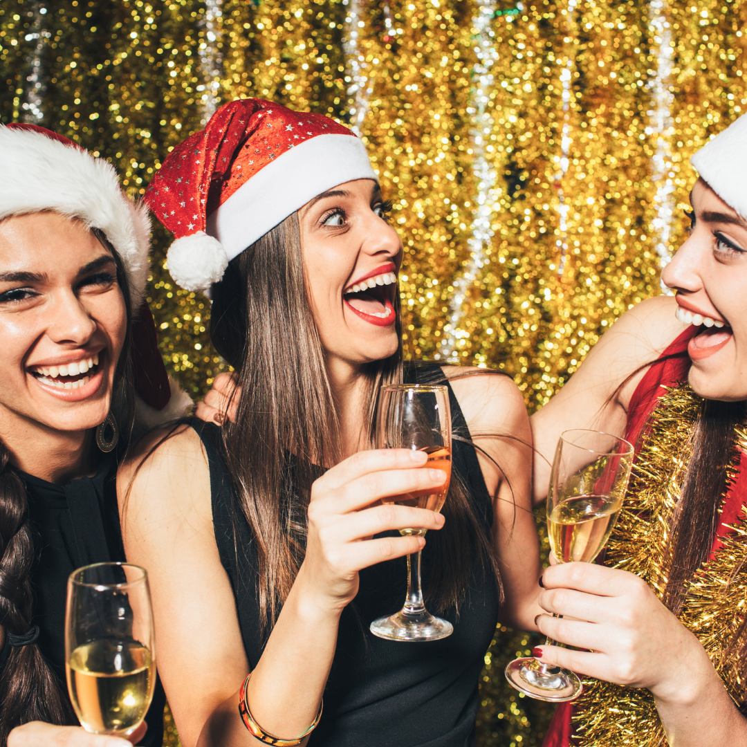 Ladies in Santa hats drinking champagne